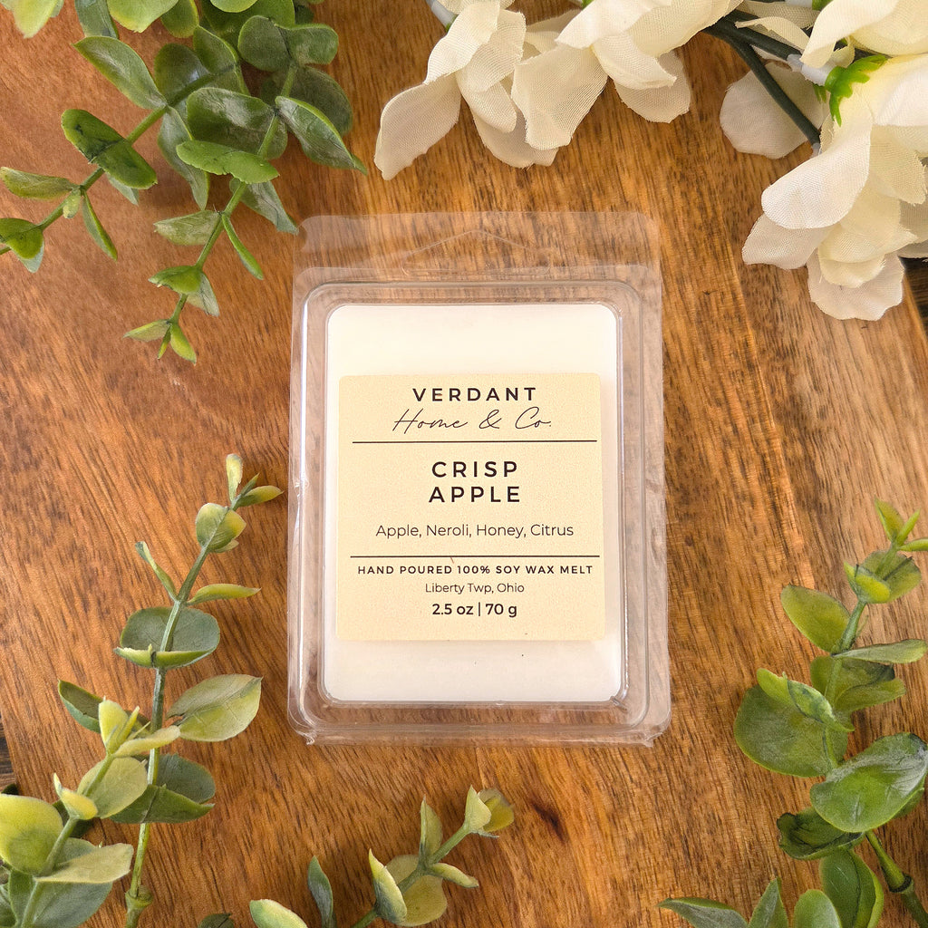 Verdant Home & Co Crisp Apple wax melt on a wooden surface with greenery