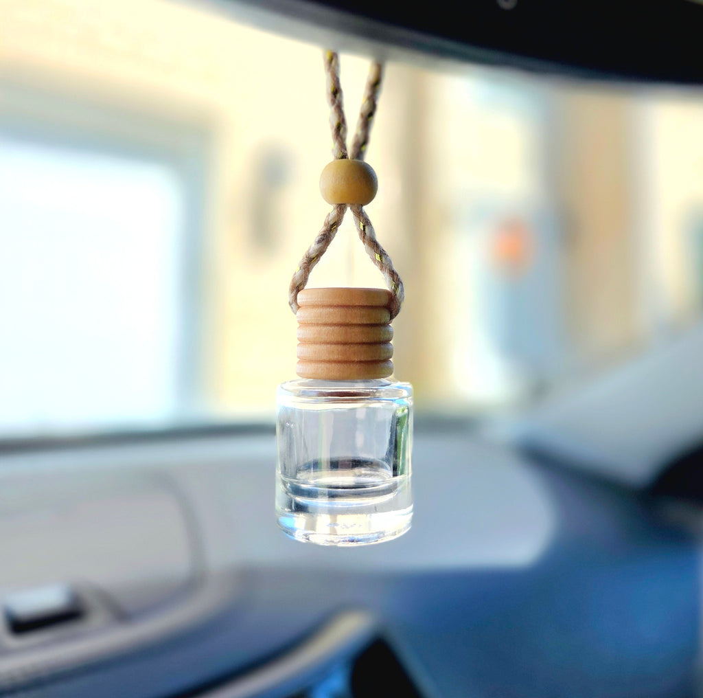 Hanging diffuser displayed hanging from car rear view mirror.